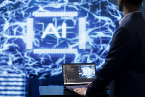 Programmer using AI cognitive computing on laptop