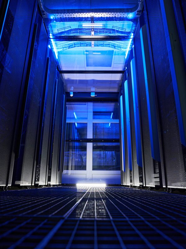 Close up image of server room with different server racks and metal panel